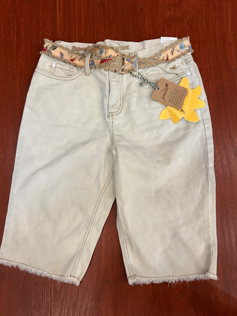 Grane cream denim shorts with floral woven belt and sunflower tag